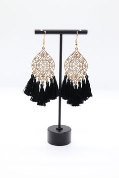 This is a pair of gold filigree earrings with black tassels. They are very pretty and would be a great addition to any jewelry collection. Elegant Black Jewelry With Latkans, Bohemian Black Tassel Earrings As Gift, Black Bohemian Jewelry With Tassels, Elegant Black Dangle Tassel Earrings, Black Fringe Dangle Jewelry, Elegant Black Tassel Drop Earrings, Black Tassel Drop Earrings, Black Dangle Jewelry With Fringe, Black Filigree Earrings