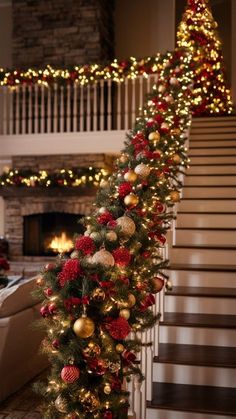 a christmas tree with red and gold ornaments on it in front of a stair case