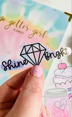 someone is holding up a sticker with the word shine on it