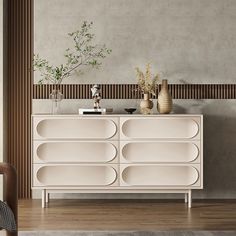 a white dresser with vases and plants on top