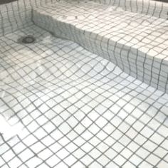 a bathroom with a white sink and tiled floor