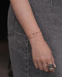 a woman's hand with a small tattoo on it