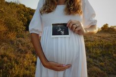 a pregnant woman holding an album in her hands