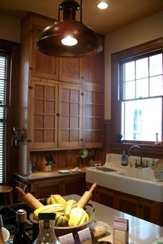 a kitchen filled with lots of counter top space next to a sink and window covered in blinds