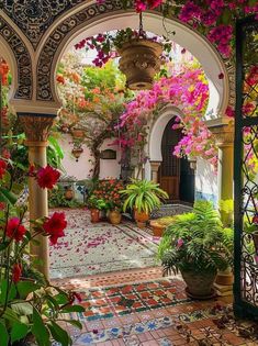 an archway with potted plants and flowers in it