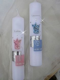 two white candles with different designs on them