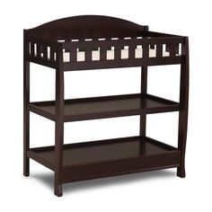 a wooden baby crib with two shelves on the bottom and one shelf below it