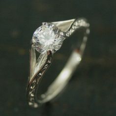 a white gold ring with a diamond in the center