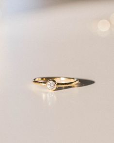 Our Solitaire Ring has the perfect everyday sparkle! Made of 14k gold fill, so you'll never have to take it off. Features a sparkly cubic zirconia. Pair with our plain gold stacking ring or any of our other rings for a dainty look! Adjustable Solitaire Rings For Everyday, Adjustable Hypoallergenic Stackable Rings For Everyday, Hypoallergenic Adjustable Stackable Rings For Everyday, Everyday Solitaire Rings, Everyday Stackable Midi Rings, Adjustable Bezel Set Rings For Everyday, Simple Everyday Stackable Rings With Single Diamond, Everyday Stackable Rings With Bezel Setting, Everyday Midi Rings With Bezel Setting