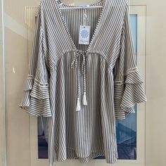 Grey And White Striped With Tie Front And Mid Length Bell Sleeves. 100% Rayon. Size Small, Never Been Worn With Original Tag. Beachy V-neck Top For Day Out, Casual Beach Season Blouse For Brunch, Casual Blouse For Beach Season Brunch, Casual Blouse For Brunch During Beach Season, Casual V-neck Beach Dress For Day Out, Casual V-neck Cover-up For Day Out, Spring Vacation Beachwear Blouse, Spring Beachwear Blouse For Vacation, White Summer Blouse For Vacation