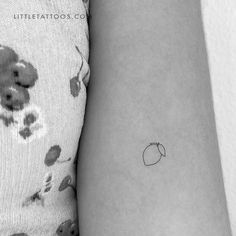 a small apple tattoo on the left inner arm by littletattoos com in black and white