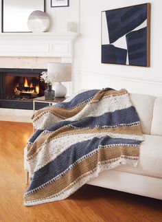 a living room with a white couch and fireplace