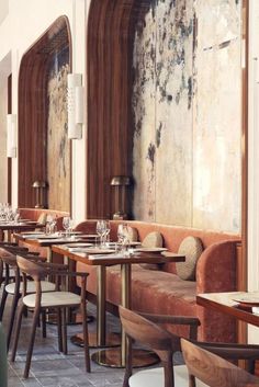 an empty restaurant with wooden tables and chairs