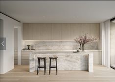 two stools sit in front of an island with marble countertops and bar seating