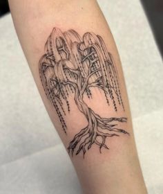 a black and white photo of a tree tattoo