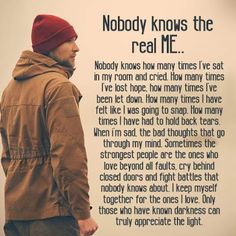 a man standing in front of a white wall with a poem written on it that says nobody knows the real me