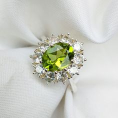 "Dainty Peridot Ring, Peridot stacking Ring, Green Peridot and CZ Ring, Luxury Ring, Sterling Silver Ring, Delicate Ring, Bridesmaid Gift Specifications :- ❥ Stone - Natural Peridot ❥ Stone Size - 6x8mm  ❥ Cut Type - Oval ❥ Side Stones- Simulated diamonds Cz ❥ Ring Size: I offer more than one (Contact us if your ring size is not available in the listing) ❥ Color: Silver, Gold, Rose Gold, White Gold or Black Rhodium ❥ Material : 925 Sterling Silver, 14K/18K/22K Solid Gold --> ❥ Makes a Wonderful Gift for your Girlfriend, Wife, Mother and Friend or Simply an Excellent Addition to Your Jewelry Collection -->IF YOU WANT CUSTOM ENGRAVING ON YOUR RING VISIT OUR LISTING HERE: It's Only 2 USD https://www.etsy.com/listing/1436332485/custom-engaraving - -Here's a link to my HOMEPAGE: Johrifinejewell Ring Luxury, Luxury Ring, Purple Amethyst Ring, Pear Ring, Peridot Stone, Etsy Bridesmaid Gifts, Luxury Rings, Peridot Ring, Green Peridot