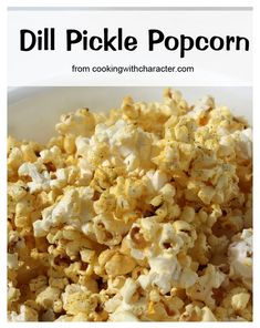 a bowl full of popcorn with the words dil pickle popcorn on it in black and white