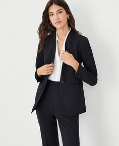 Elevate your wardrobe with the Ann Taylor Long Collarless Blazer, a masterpiece of refined elegance and versatility. This blazer is impeccably tailored from fluid crepe fabric, offering a sleek and sophisticated silhouette without a collar, making it a timeless piece for any occasion.

- **Size**: 0
- **Color**: Black
- **Material**: 95% Polyester, 5% Spandex
- **Gender**: Female
- **Fit**: Tailored fit
- **Length**: Hits at hip, 27" long
- **Sleeves**: Long, button-open sleeves for styling flex Collarless Blazer Outfits For Women, Black Blazer Outfit Work Business Professional Women, Black Blazer Outfit Dressy, Tailored Suit Women, Black Suit Women, Black Suit For Women, Modern Tailoring, Black Blazer Outfit, Collarless Blazer