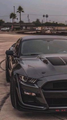 a black sports car parked in a parking lot