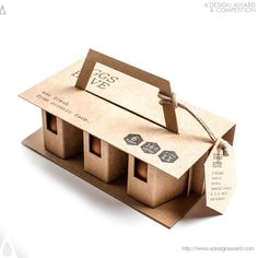 a cardboard box that has some kind of house in it with tags on the front