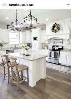 a kitchen with white cabinets and an island in the center, surrounded by two stools