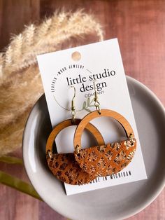 New Design from Little Studio Design Co! Gorgeous Ginger Leopard Suede Hoop Earrings! Lightweight and full of style! Perfect for everyday or something extra! Beautiful cherry wood arch paired with a Ginger Leopard Suede Leather! Beautiful russet colored leather with a gold metallic leopard print.  These earrings are beautiful! *Nickel free Earwire *Handmade in Michigan *1.5in diameter Thank you so much for supporting our shop! We love your support and your referrals! Brown Small Hoop Earrings With Ear Wire, Brown Hoop Earrings With Ear Wire, Brown Single Hoop Earring As Gift, Brown Hoop Earrings Gift, Brown Hoop Earrings With Ear Wire For Gift, Nickel-free Brown Hoop Earrings As Gift, Brown Small Hoop Earrings As Gift, Brown Round Hoop Earrings For Gift, Brown Circular Earrings For Gifts