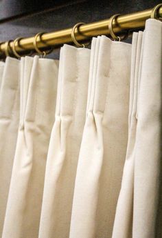 white curtains with gold metal rods hanging from them