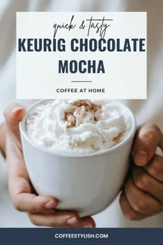 a person holding a cup of coffee with whipped cream on top and the words keurig chocolate mocha above it