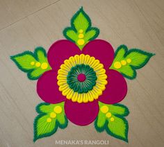 an image of a flower made out of paper on the floor with green leaves and yellow centers