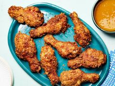 fried chicken on a blue plate next to sauce