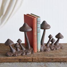 the bookend is made out of wood and has several mushrooms on top of it