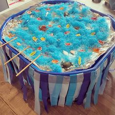 a large blue and white cake sitting on top of a wooden table next to two chopsticks