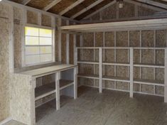 an unfinished room with wooden walls and shelves