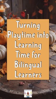 a wooden table topped with lots of pumpkins next to a sign that says turning playtime into learning time for bilingual learners