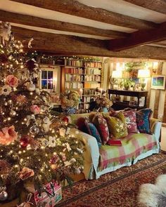 a living room with a christmas tree in the corner and lots of bookshelves