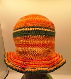 an orange and green striped hat sitting on top of a table