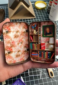 there is a miniature book case with books in it