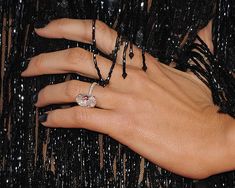 a close up of a person's hand with a ring on it