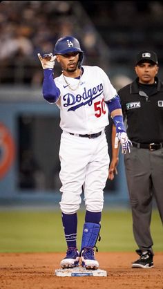 a baseball player standing on top of a base