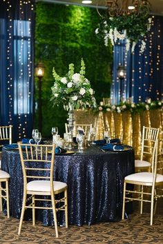 a table set up with blue and gold linens