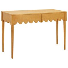 a wooden table with scalloped legs and a drawer on one side, against a white background