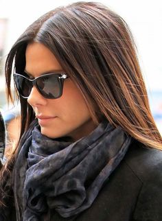 a woman wearing sunglasses and a scarf