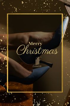 a pair of blue high heels sitting on top of a wooden table next to a christmas card