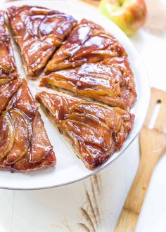 an apple pie is cut into slices on a plate