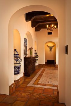 an archway leading to a hallway with vases on the wall and other decorative items