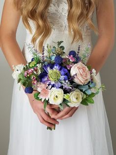 a woman holding a bouquet of flowers in her hands