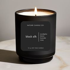 a black candle sitting on top of a table