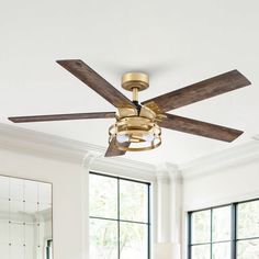 a living room with a couch, table and ceiling fan in the middle of it