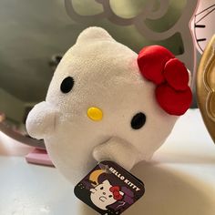 a hello kitty stuffed animal sitting on top of a table